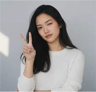 Half-body, front-facing, head slightly tilted right, eyes looking at the camera with a neutral expression; right hand raised in a peace sign, left arm crossed over torso; shoulders relaxed, torso upright; eye-level camera angle, medium crop.